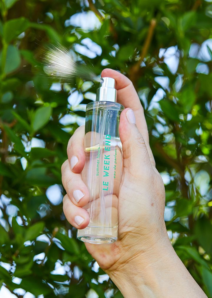 Le Week End fragrance being sprayed outdoors