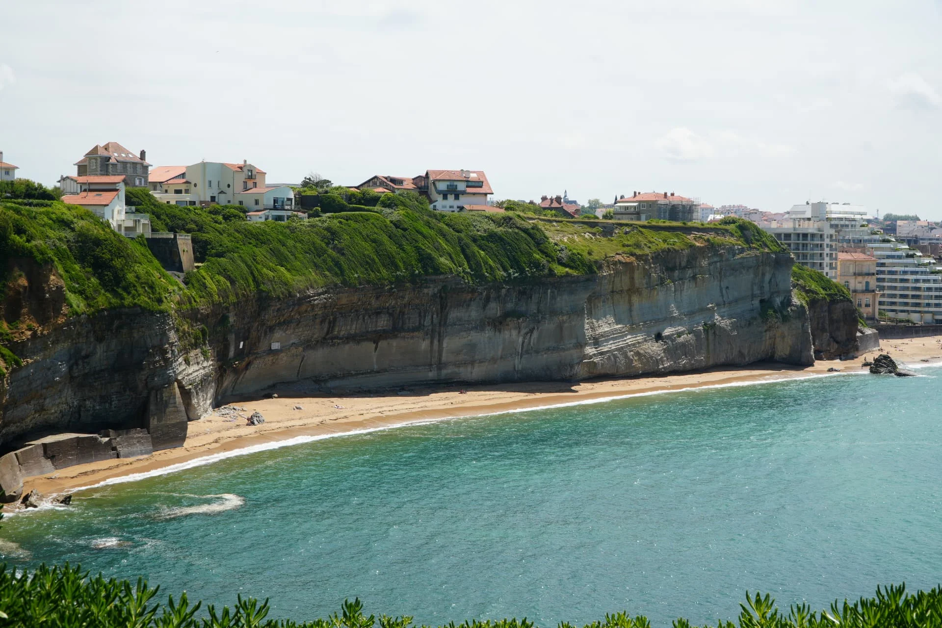 Ocean beside a green coastal headland